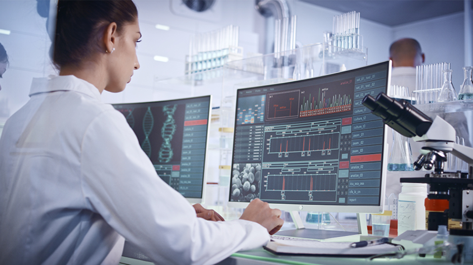 Female scientist sitting in front of computer looking at data